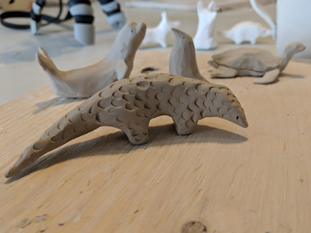 Sculpting a clay pangolin