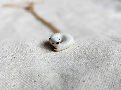 Winter stoat ceramics and gold pendant