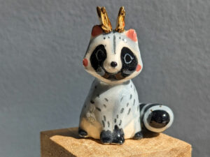 antlered raccoon porcelain figurine