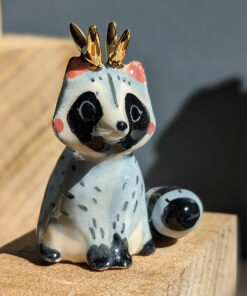 antlered raccoon porcelain figurine