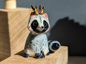antlered raccoon porcelain figurine