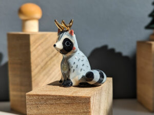 antlered raccoon porcelain figurine