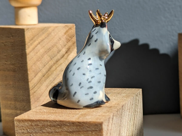 antlered raccoon porcelain figurine