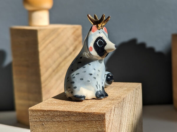 antlered raccoon porcelain figurine