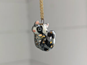 porcelain raccoon pendant