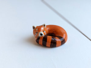 porcelain red panda figurine