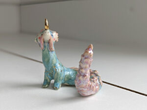 cute east dragon porcelain figurine in blue pink and gold