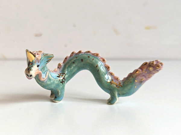 cute east dragon porcelain figurine in blue pink and gold