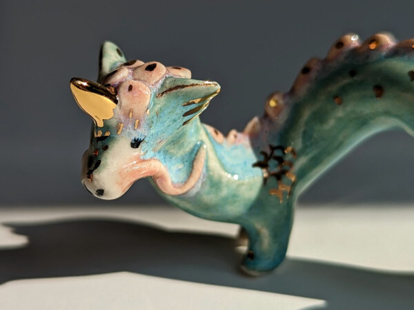 cute east dragon porcelain figurine in blue pink and gold