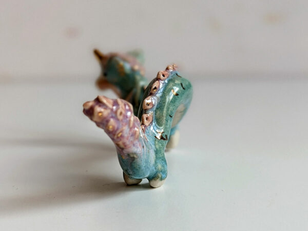 cute east dragon porcelain figurine in blue pink and gold