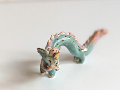 cute east dragon porcelain figurine in blue pink and gold