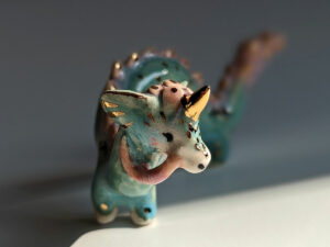 cute east dragon porcelain figurine in blue pink and gold