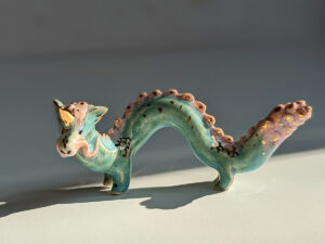 cute east dragon porcelain figurine in blue pink and gold