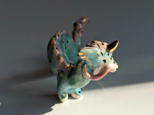 cute east dragon porcelain figurine in blue pink and gold