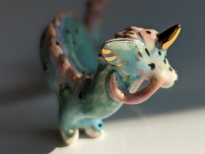 cute east dragon porcelain figurine in blue pink and gold