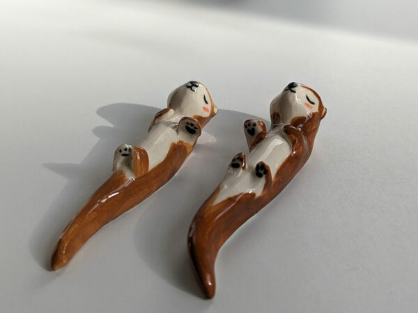 figurines couple otters