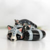 adorable porcelain figurine of a raccoon family sleeping collectible