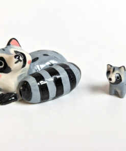 adorable porcelain figurine of a raccoon family sleeping collectible