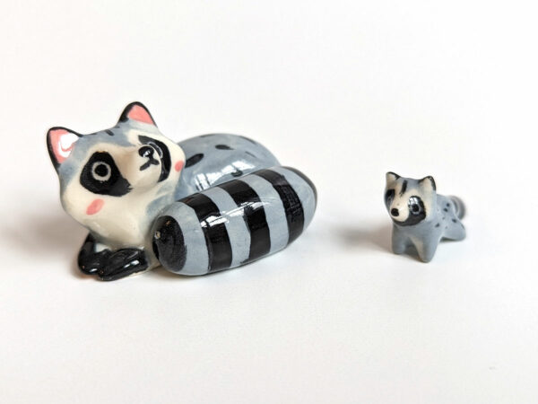 adorable porcelain figurine of a raccoon family sleeping collectible