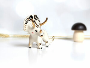 porcelain triceratops figurine with gold