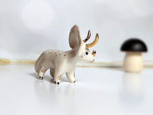 porcelain triceratops figurine with gold