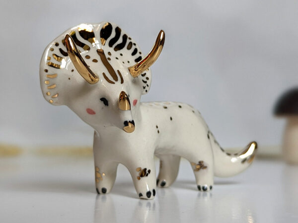 porcelain triceratops figurine with gold