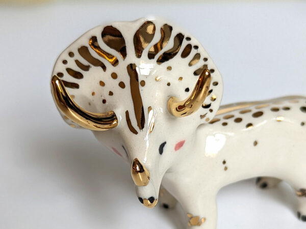 porcelain triceratops figurine with gold