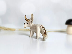 porcelain triceratops figurine with gold