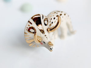 porcelain triceratops figurine with gold