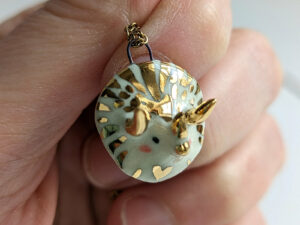 handmade porcelain cute triceratops pendant