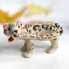 snow leopard munching tail porcelain figurine