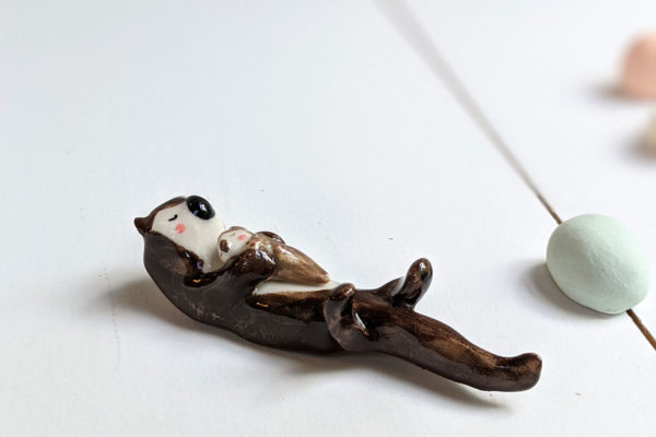 porcelain otter mom and baby figurine