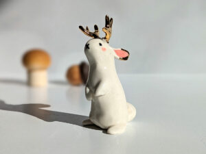 jackalope figurine with golden antlers