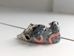 extremely cute opossum mama figurine sleeping with babies - kness