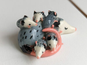extremely cute opossum mama figurine sleeping with babies - kness