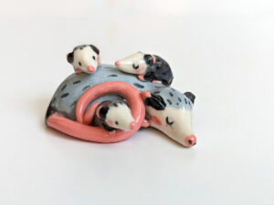 extremely cute opossum mama figurine sleeping with babies - kness