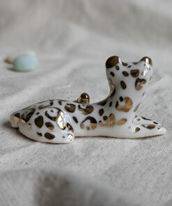gold and porcelain snow leopard figurine