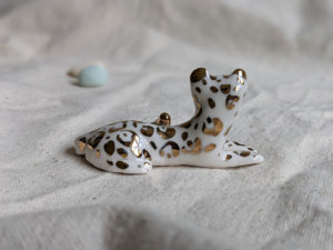 gold and porcelain snow leopard figurine