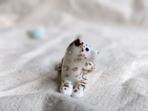 gold and porcelain snow leopard figurine