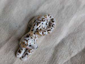 gold and porcelain snow leopard figurine