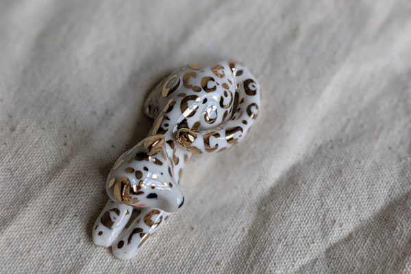 gold and porcelain snow leopard figurine