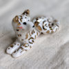 gold and porcelain snow leopard figurine