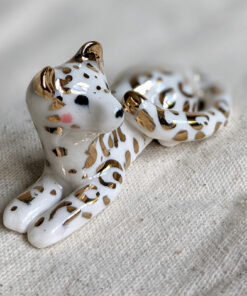 gold and porcelain snow leopard figurine