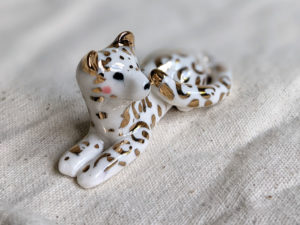 gold and porcelain snow leopard figurine