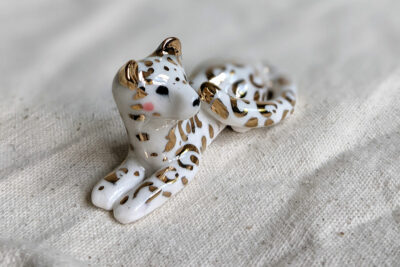 gold and porcelain snow leopard figurine