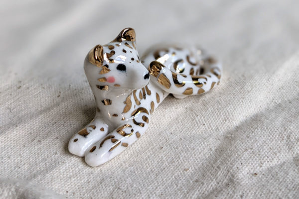 gold and porcelain snow leopard figurine