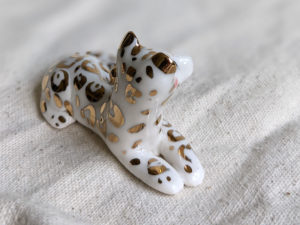 gold and porcelain snow leopard figurine