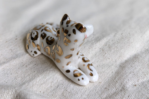 gold and porcelain snow leopard figurine