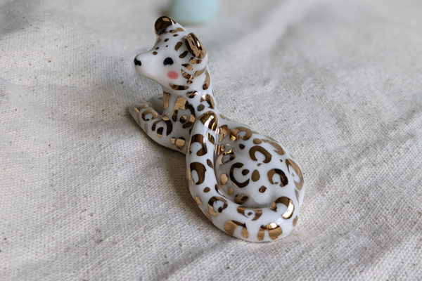 gold and porcelain snow leopard figurine