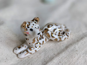 gold and porcelain snow leopard figurine